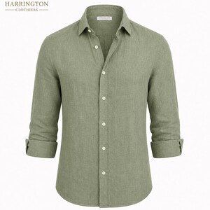 May include: A sage green long-sleeve button-down shirt with a classic collar and rolled cuffs. The shirt features a front button placket with light-colored buttons and a small interior label reading Harrington Clothiers at the neckline.