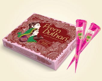 May include: A rectangular box and two cones of Prem Dulhan henna. The pink box features an illustration of a person with dark hair and a green head covering, intricate maroon paisley patterns, and the text 100% NATURAL HENNA No Chemical Dye.