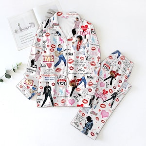 May include: White pyjama set with images of Elvis Presley, hearts, and lipstick prints. The set includes a button-down shirt and matching trousers. The text "Elvis", "Stuck on You", and other phrases are scattered across the fabric.