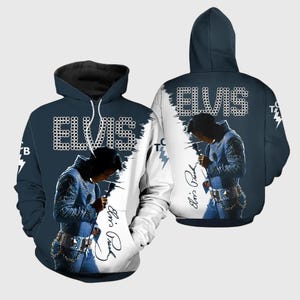 May include: A navy blue hoodie with a graphic of Elvis Presley in a blue jumpsuit, holding a microphone. The word "ELVIS" is displayed in white, dotted letters. The hoodie also includes a signature and a lightning bolt graphic.