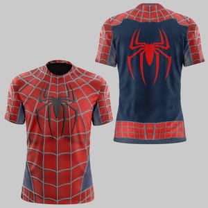 May include: A red and blue short-sleeved shirt featuring a spiderweb design and a large black spider emblem on the front. The back of the shirt is blue with a red spider emblem. The shirt has a round neck and is likely made of a breathable fabric.