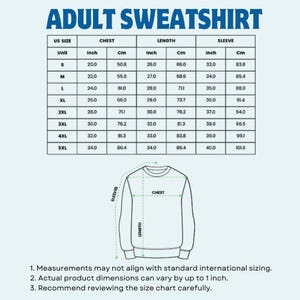 May include: A size chart for adult sweatshirts, displaying measurements in inches and centimetres. The chart includes sizes S to 5XL, detailing chest, length, and sleeve dimensions. A diagram of a sweatshirt with measurement points is also shown.