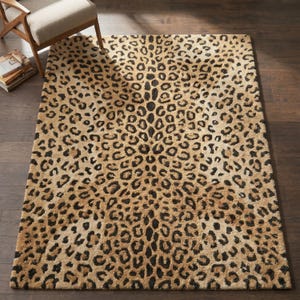 May include: A rectangular area rug featuring a repeating leopard print pattern in shades of tan, beige, and black. The rug has a textured, pile surface and covers a significant portion of the floor space, displaying a consistent animal-inspired design.