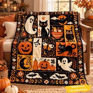 May include: A black, orange, and white throw blanket featuring a grid of Halloween-themed illustrations including ghosts, black cats, jack-o'-lanterns, bats, an owl, a bowl of candy, and a moth, all framed by a floral border pattern.