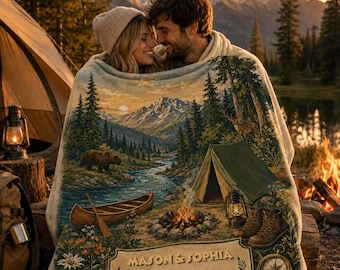 May include: A soft throw blanket featuring a printed landscape of a mountain range, a river, a forest, a bear, a canoe, a tent, and a campfire. The design includes a banner with the text "MASON & SOPHIA" and "EST. 2026" above a compass graphic.
