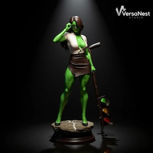 May include: A green-skinned figurine of a woman wearing a white top, brown skirt, and glasses, holding a traffic light. The figure stands on a stone base with a dark wooden stand. The VersaNest Studio logo is visible in the upper right corner.