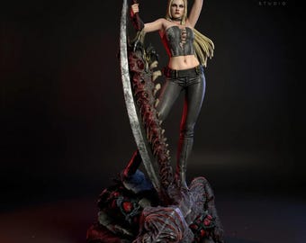 May include: A detailed statue of a female warrior with long blonde hair, wearing a black corset, pants, and holding a large scythe and two pistols. The statue is on a detailed base with a dark background.