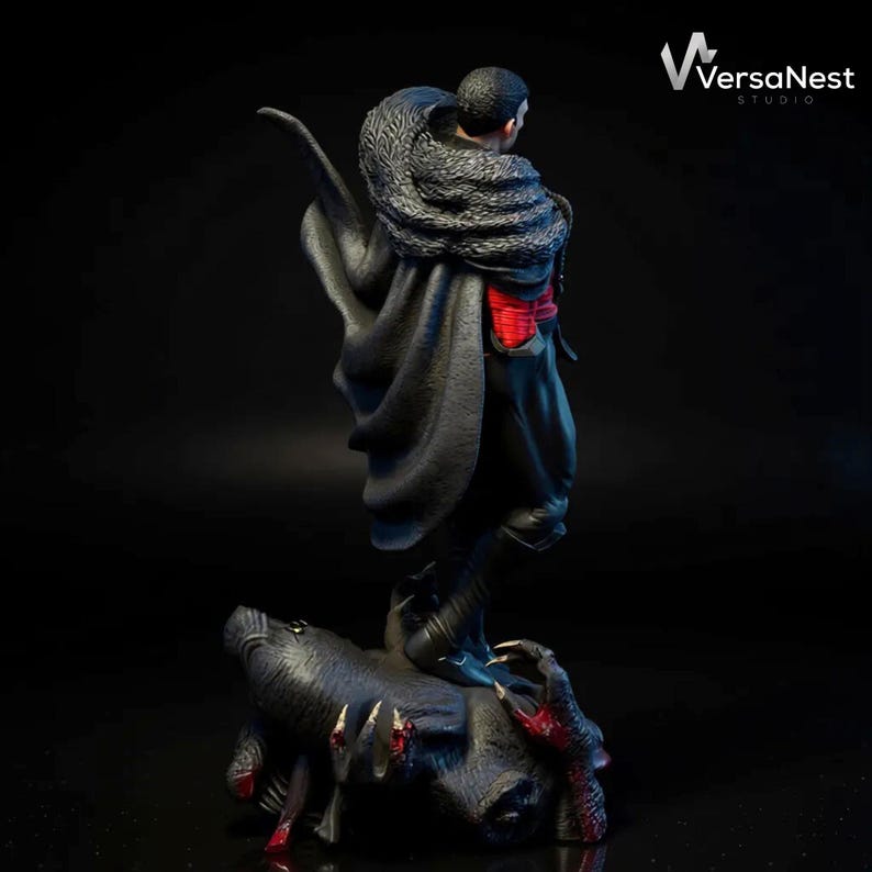 May include: A detailed statue of a figure in a black cloak with a fur collar, red accents, and a dark base with clawed hands. The statue is from VersaNest Studio.
