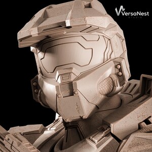 May include: A detailed, weathered, tan-colored helmet, reminiscent of a science fiction space suit. The helmet features a visor, intricate paneling, and a textured surface. The VersaNest Studio logo is visible in the upper right corner. The background is black.