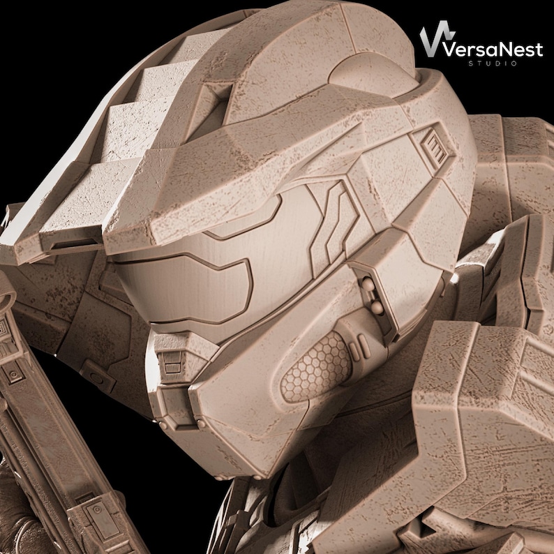 May include: Close-up of a detailed, weathered, tan-colored helmet, likely from a science fiction or video game context. The helmet features angular designs, a visor, and intricate paneling. The VersaNest Studio logo is visible in the upper right corner.