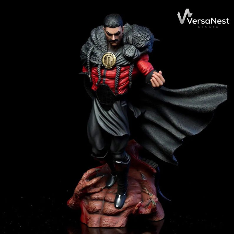 May include: A detailed figurine of a man in a red and black outfit with a black cape. The figure has a stern expression and is standing on a reddish-brown base. The figure has a gold emblem on the chest and a fur collar.