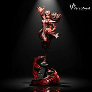 May include: A detailed statue of a female character in a dynamic pose, clad in a red and black costume. The figure is holding glowing red energy in her hands, with flowing red energy effects around the base. The statue is on a black base.