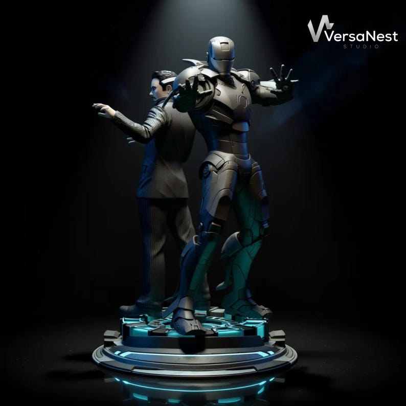 May include: A detailed statue featuring two figures: a man in a suit and a metallic armored superhero. The superhero is in a dynamic pose with outstretched hands. The base has blue neon lighting. The VersaNest Studio logo is visible.