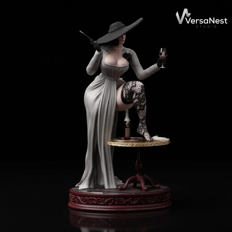 May include: A detailed figurine of a woman in a long grey dress, black hat, and gloves, holding a cigarette and a wine glass. She is posed with one leg resting on a small table with a wine bottle. The base is dark red.