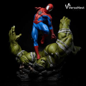 May include: A detailed statue of Spider-Man standing over a defeated Hulk. Spider-Man is in his classic red and blue suit. The Hulk is green with torn bandages. The base is a rocky terrain. The statue is set against a black background.