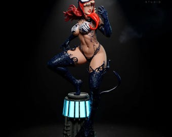 May include: A detailed figurine of a female character with red hair and a white and black mask. The figure is wearing a black bodysuit with dark blue accents and stands on a platform with a blue light. The VersaNest Studio logo is in the upper right corner.