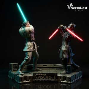 May include: A detailed statue depicting a scene from Star Wars: Episode I - The Phantom Menace. Two figures are posed in a lightsaber duel, one with a blue lightsaber and the other with a red one. The base features the movie title.