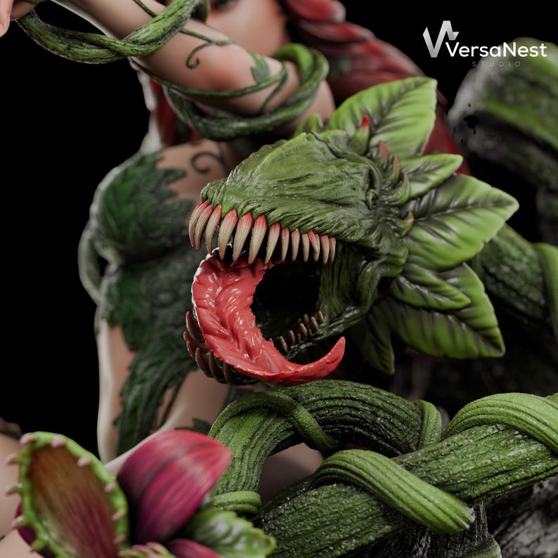 May include: A detailed sculpture featuring a green, plant-like creature with sharp teeth and a red tongue. The sculpture has a dark background and includes green vines and red and green plant details. The VersaNest Studio logo is visible in the upper right corner.