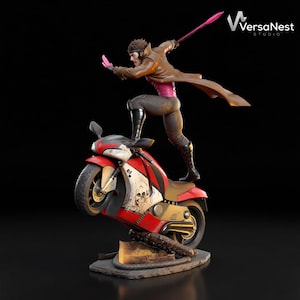 May include: A detailed figurine of the Marvel Comics character Gambit, poised on a red and white motorcycle. Gambit is wearing a brown trench coat, pink shirt, and black boots. The motorcycle has a skull graphic.