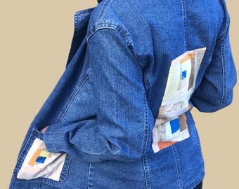 Upcycled blue denim jacket with designer handmade patchwork back and pocket panels, in patchwork cotton, one- of- a- kind.