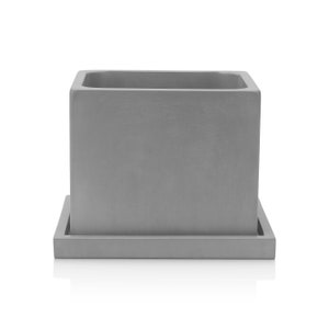 May include: A gray concrete planter with a square shape and a matching saucer. The planter has a smooth, slightly textured surface.