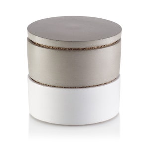 May include: A two-piece concrete storage container with a lid. The top piece is a light gray color and the bottom piece is white.