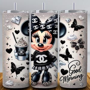 May include: Three stainless steel tumblers with a Minnie Mouse design. The design includes Minnie Mouse wearing a black bow and sweater, holding a coffee cup. The tumblers are decorated with black butterflies, hearts, and the words "Good Morning".
