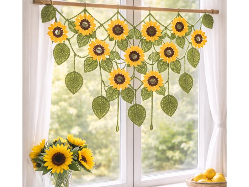 May include: A crochet window valance featuring a series of interconnected yellow sunflowers with dark brown centers and green leaves, suspended from a wooden rod. The design includes multiple hanging sunflower motifs and foliage elements.