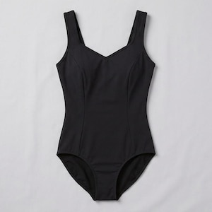 May include: A solid black one-piece swimsuit featuring a sweetheart neckline, wide shoulder straps, and vertical seam detailing along the front bodice. The garment has a high-cut leg opening and a smooth, matte fabric finish throughout the design.