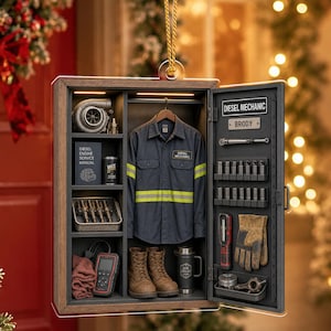 May include: A rectangular hanging ornament shaped like a locker, featuring a dark blue work shirt with reflective stripes, a turbocharger, a diesel engine service manual, a Wix oil filter, fuel injectors, a diagnostic tool, boots, and a thermos.