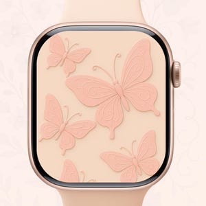 May include: A rose gold smartwatch with a pale peach strap. The watch face features a pattern of embossed pink butterflies on a peach background. The butterflies have detailed wing patterns.