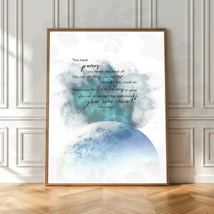 May include: A framed art print featuring a quote about inner strength and potential. The artwork has a watercolor-style background with blue and teal hues, and a stylized image of a planet. The quote reads, "You have powers you never dreamed of."