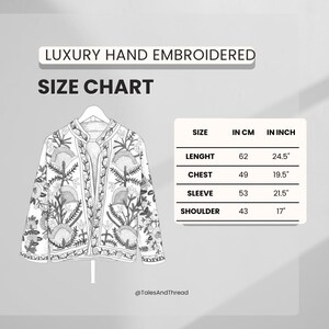 May include: A white, hand-embroidered jacket with a floral design, displayed on a hanger. The image includes a size chart with measurements in inches and centimeters. The jacket's length is 24.5 inches (62 cm).