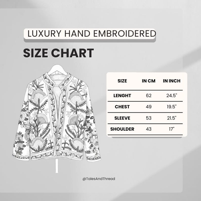 May include: A white, hand-embroidered jacket with a floral design, displayed on a hanger. The image includes a size chart with measurements in inches and centimeters. The jacket's length is 24.5 inches (62 cm).