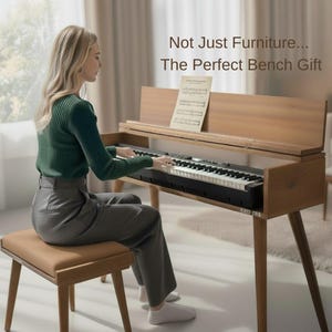 May include: A wooden piano with a keyboard and a bench. The piano has a light brown finish and a black keyboard. The bench is upholstered in a light brown material. The text on the image says "Not Just Furniture... The Perfect Bench Gift".
