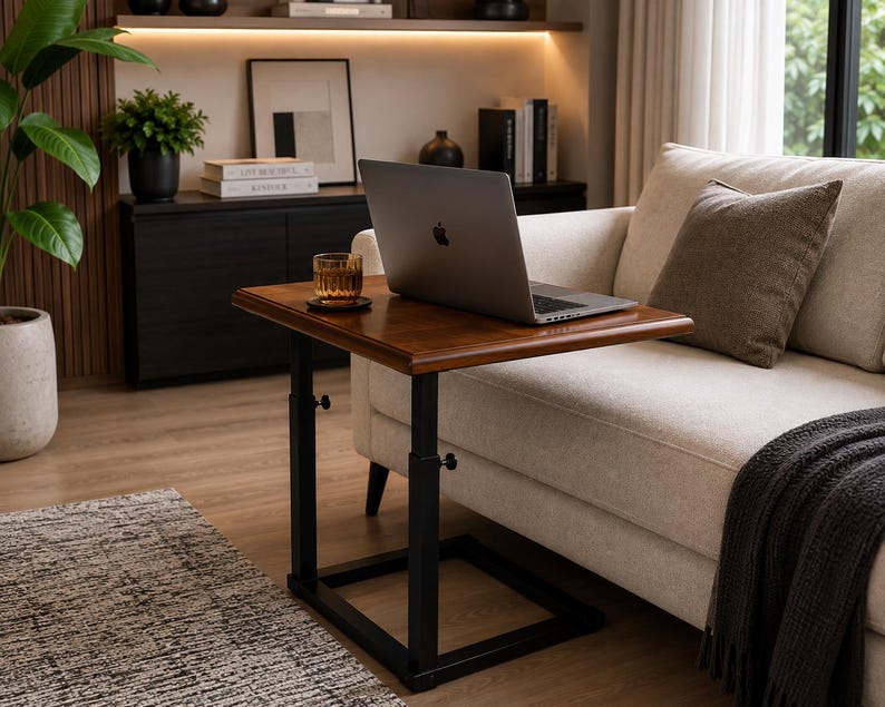 May include: A height-adjustable side table with a rectangular wooden top and a black metal frame. The table features two vertical support posts with visible adjustment knobs, a flat base, and a smooth, polished finish on the wooden surface.