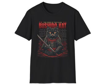 May include: Black t-shirt featuring a graphic of a samurai cat holding a katana. The design includes the text "BUSHIDO KAT" in red, with Japanese characters and the phrase "THE CODE OF THE CLAW" above the cat.