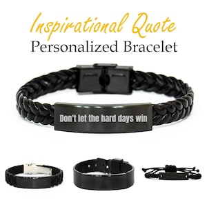 Puede incluir: Pulsera de cuero trenzado negro con cierre metálico y placa rectangular grabada con el texto "Don't let the hard days win". La imagen también muestra otras tres pulseras negras con diferentes diseños. El texto "Inspirational Quote Personalized Bracelet" está en la parte superior.