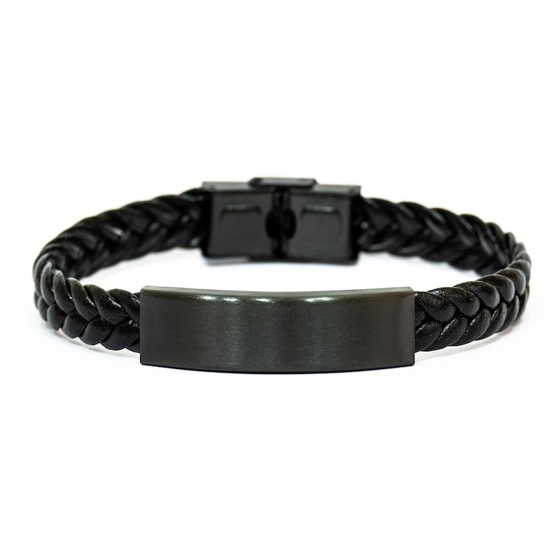 May include: Black braided leather bracelet with a matte black metal clasp and a rectangular metal plate. The bracelet is designed with a woven pattern and a secure clasp.