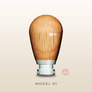 May include: A light brown wooden gear shift knob with a smooth, polished finish and vertical grain patterns. The base is a solid silver-coloured metal component with two visible side screws. The text MODEL 01 is printed below the object.
