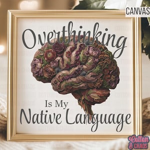 May include: A framed canvas print with a gold-colored frame. The artwork features a detailed illustration of a brain composed of flowers and foliage. The text reads "Overthinking Is My Native Language" in a dark gray font.