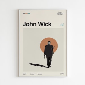May include: A framed poster featuring the movie title "John Wick" in bold black letters. The poster depicts a silhouette of a man walking with a gun, set against an orange circle. The overall design is minimalist.