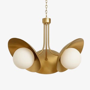 May include: A gold-toned chandelier with three curved, petal-like shades. Each shade cradles a spherical, white light. The fixture hangs from a chain and features a central stem with multiple supporting rods.