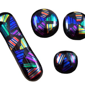 May include: A collection of four dichroic glass pieces. The pieces include a long, curved shape and three round shapes. Each piece is black with colorful, iridescent geometric patterns in shades of blue, purple, yellow, and orange.