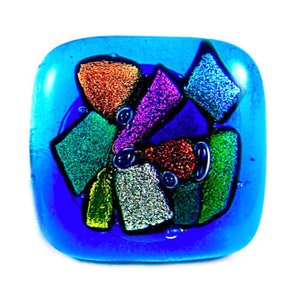 May include: A square, dichroic glass pendant in shades of blue, with colorful, textured glass pieces in orange, green, purple, and silver. The glass has a glossy finish and is set against a white background.