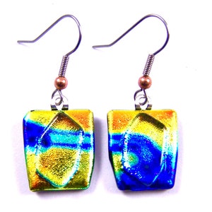 May include: A pair of square dangle earrings with a dichroic glass design. The earrings feature a vibrant mix of colors, including yellow, orange, and blue. The hooks are silver-toned with a copper-colored bead accent. The earrings are designed to be lightweight and eye-catching.