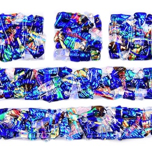 May include: A mosaic of blue, iridescent, and gold glass tiles arranged in a rectangular pattern. The tiles are set in a clear epoxy resin.