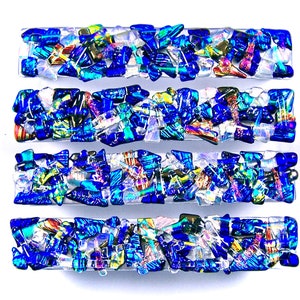 May include: Four rectangular pieces of glass art with a mosaic of blue, iridescent, and white glass pieces.