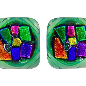 May include: A pair of square-shaped earrings with a green background and a colorful geometric design inside. The design features iridescent colors like red, orange, yellow, green, blue, and purple.