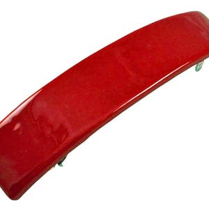 May include: A bright red plastic hair clip with a curved shape. The clip has a smooth, glossy finish.